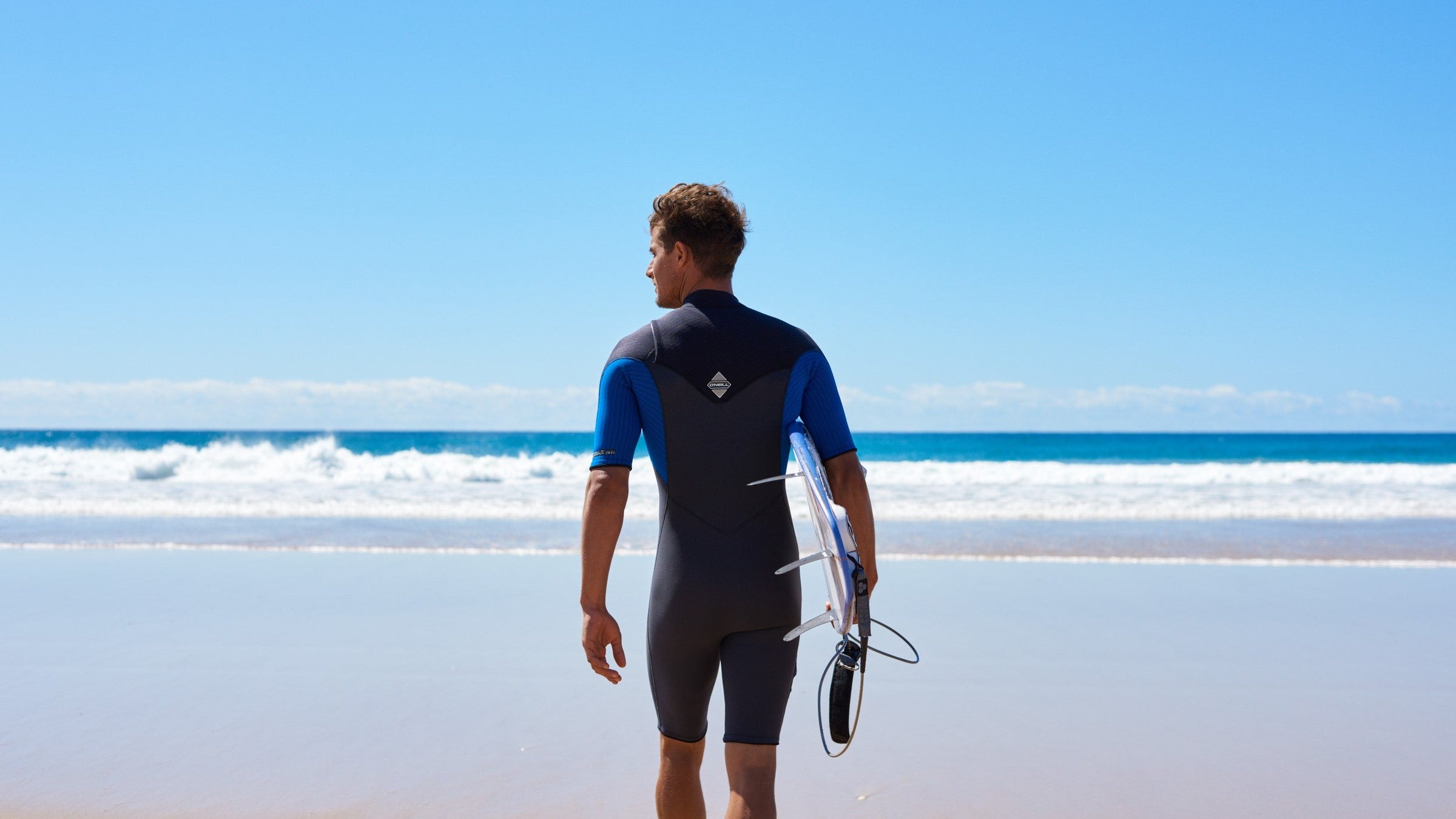 man on beach in springsuit