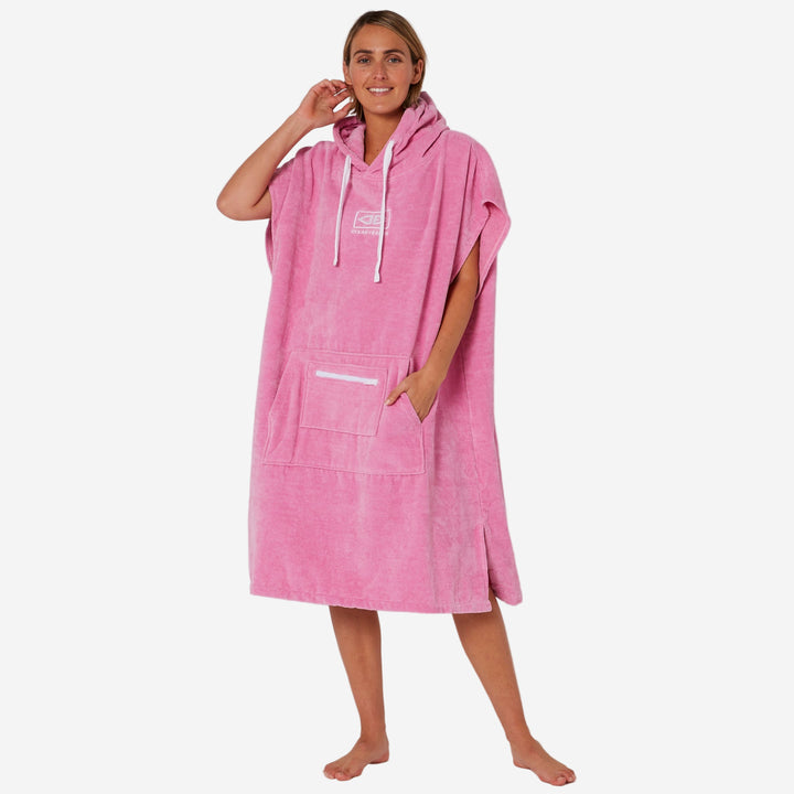 Person wearing a pink hooded towel against a white background