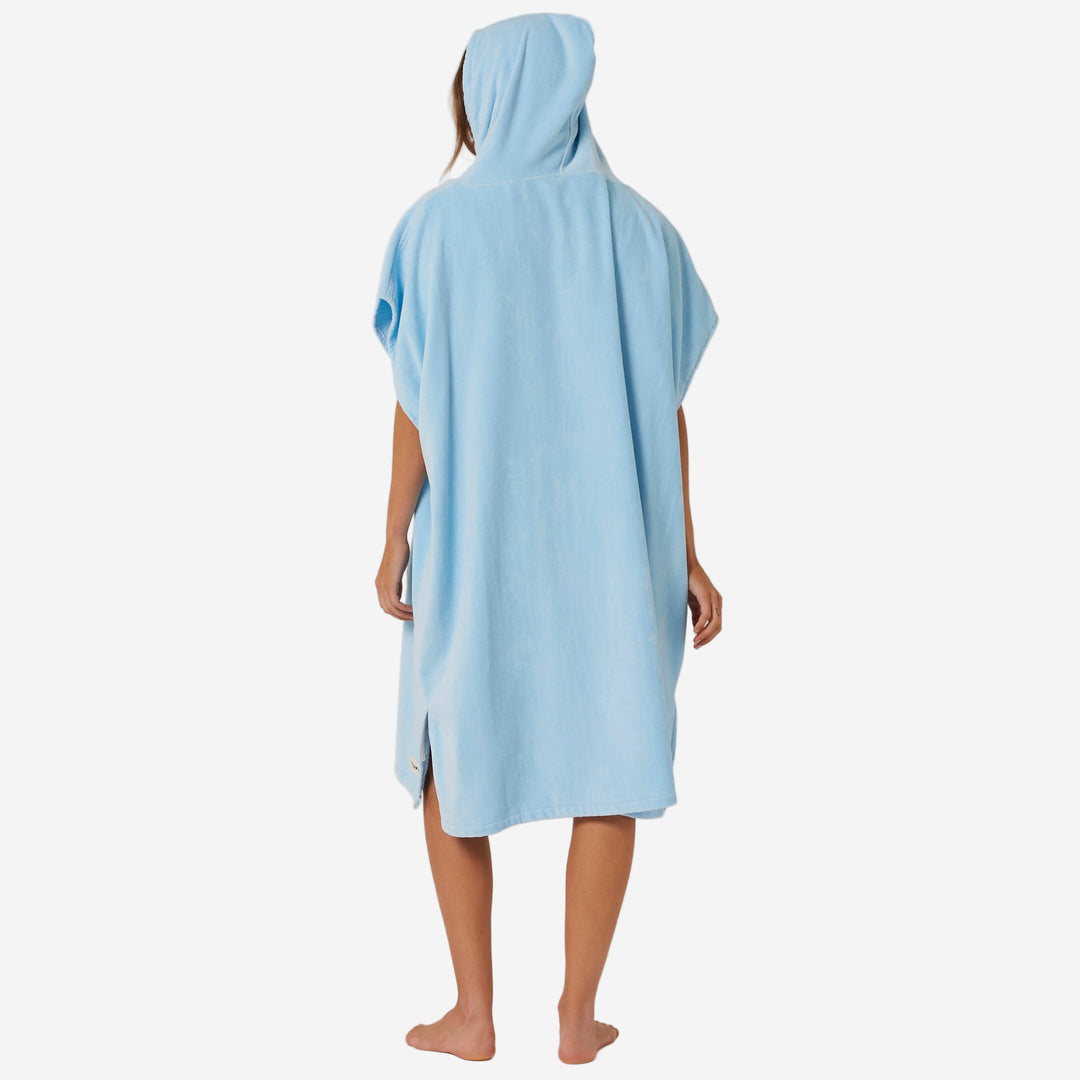 Person wearing a light blue hooded towel on a plain background