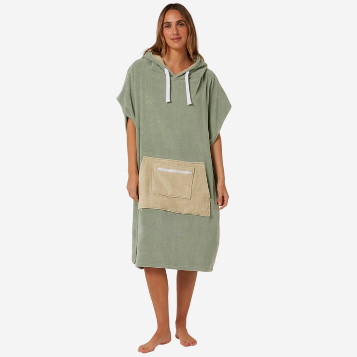 Woman wearing a green hooded towel with a beige pocket on a white background