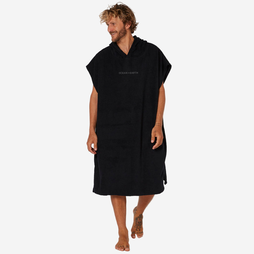 Man wearing a black hooded towel with 'OCEAN & Earth' branding on a white background