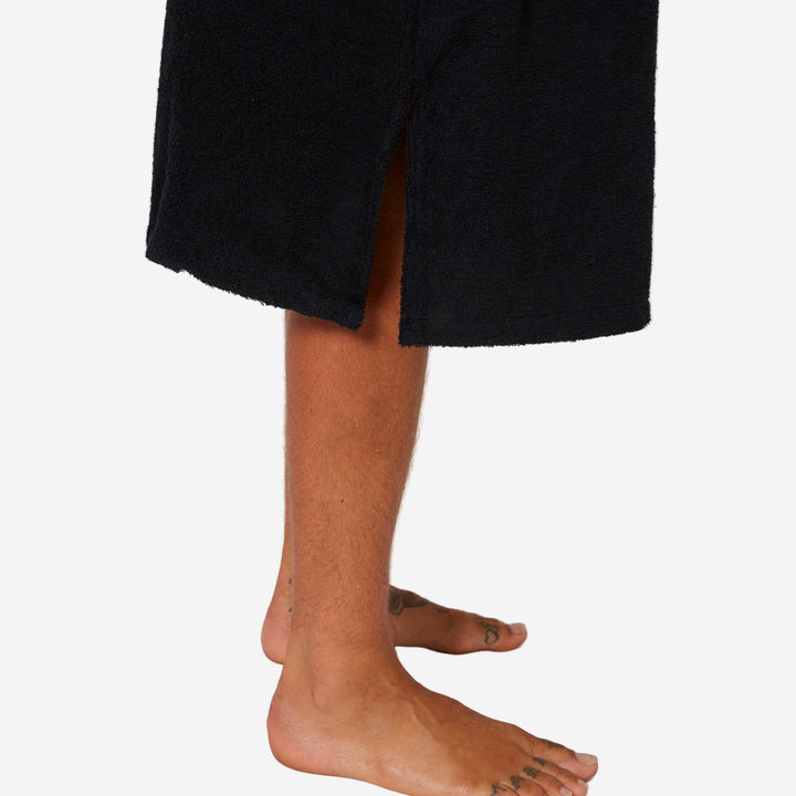 Person wearing a black robe with a neutral background